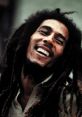 Bob Marley smiling, showcasing his iconic dreadlocks and joyful spirit, embodying reggae music and cultural influence.