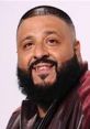 DJ Khaled smiling with a stylish haircut and beard, wearing a trendy jacket, radiating confidence and positivity.