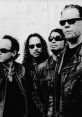 Metallica band members in black leather jackets, showcasing their iconic style and strong presence in a monochrome setting.