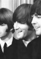 Three members of The Beatles smiling, showcasing their iconic hairstyles and suits during a classic 1960s photoshoot.