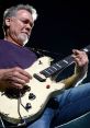 Eddie Van Halen passionately playing his iconic guitar, showcasing electrifying rock energy on stage.