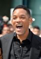 Will Smith smiling broadly at a public event, showing his charismatic personality and signature style.