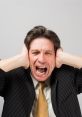 Frustrated man in a suit screaming and covering his ears, expressing annoyance and exasperation at loud noise.