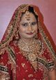 Traditional Indian bride adorned in intricate red bridal wear and elaborate jewelry, showcasing cultural richness and beauty.