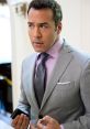 Ari Gold in a stylish suit, looking focused and gesturing, embodies the essence of a top Hollywood agent.