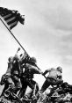 U.S. soldiers raising the American flag during World War II, symbolizing victory and bravery on the battlefield.