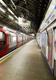 London Underground station platform with a waiting train, showcasing typical architecture and signage. Victoria Line visible.