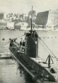 World War II submarine docked in a harbor, showcasing historical military architecture and maritime operations.