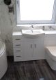 Sleek modern bathroom featuring a stylish sink, white cabinetry, and elegant marble walls, ideal for contemporary decor.