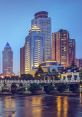 Modern skyline of Chongqing, China, featuring illuminated buildings and a traditional bridge reflected in the water.