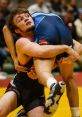 Wrestler executing a takedown in a dynamic match, showcasing strength and technique on the mat.