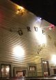 Historic dance hall venue illuminated at night, showcasing vibrant colors and rustic architecture for a lively atmosphere.