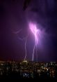 Dramatic lightning strikes illuminate a city skyline at night, showcasing the power and beauty of thunder and storms.