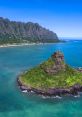 Scenic view of Chinaman's Hat, Oahu, surrounded by turquoise waters and lush mountains, ideal for outdoor activities and relaxation.