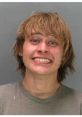 Mugshot of a young man smiling, showcasing a carefree attitude, often associated with the High Redneck culture.