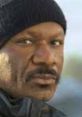 Close-up of an irate Black man wearing a black beanie, showcasing a serious expression and intense gaze.