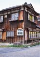 Traditional wooden building with a sign, surrounded by stone pathways, evoking a serene atmosphere for peaceful walking.