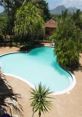 Serene pool area surrounded by lush greenery at Viking Exotic Resort, perfect for relaxation and tropical getaways.