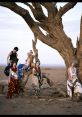 Diverse women in traditional attire pose gracefully around a weathered tree, celebrating African culture and style.