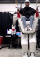 Human pilot operates a cutting-edge robotic exoskeleton in a tech lab, showcasing advancements in robotics and FX innovation.