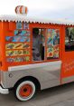 Ice cream truck with colorful menu displaying treats, featuring a cheerful attendant ready to serve delicious desserts.