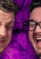 Two men laughing joyfully with a vibrant purple background, showcasing a fun moment related to TheVR gaming content.