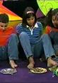 Children participating in a fun, interactive game show activity, using their feet to play with various colorful objects.