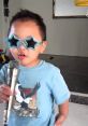 Child with star-shaped sunglasses singing into a microphone, embodying playful energy inspired by Fortnite TROLL vibes.