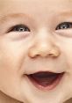 Happy baby laughing with bright blue eyes and a joyful smile, radiating pure happiness and innocence.