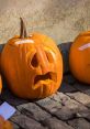 Sad-looking carved pumpkin on cobblestone, perfect for Halloween decorations and autumn festivities.