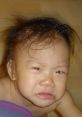 Crying baby with messy hair, showcasing emotions and innocence, perfect for illustrating parenting or childhood themes.