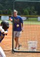 Berkeley Baseball player swings as a coach prepares to pitch during a practice session, focusing on hitting techniques.