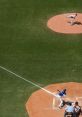 Pitcher throwing a baseball to a batter at home plate, capturing the action of a Test Baseball game in a stadium.