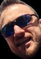 Close-up of a smiling man wearing sunglasses, epitomizing enthusiasm and engagement in a gaming context, ideal for MTG fans.