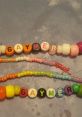 Colorful beaded bracelets spelling "GAYMER," perfect for expressing pride in gaming culture and identity.