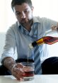 Man in a shirt and tie pouring a drink into a glass, highlighting struggles with alcohol consumption in Alabama.