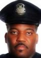 Portrait of Officer Johnson in uniform, showcasing a serious expression and traditional police cap. Dedicated law enforcement professional.