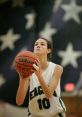 WDHS Basketball player prepares to shoot, focused on the hoop, wearing jersey number 10 and holding a Wilson ball.