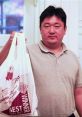 Chinese delivery guy holding a takeout bag, showcasing efficiency in food delivery service. Satisfied customer experience.