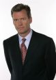 Chris Hansen in a professional suit and patterned tie, presenting a serious expression, known for investigative journalism.