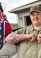 Man with Confederate flag tattoo on arm poses outdoors, showcasing a typical illustration of Southern pride.