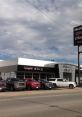 Springfield GMC dealership with various truck models displayed under a blue sky, showcasing local automotive offerings.