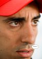 Focused expression of a driver in a red cap, capturing the intensity of Formula E Bordel with emotional dialogue.