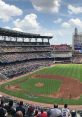 Busy ballpark scene during a 2021 baseball game, showcasing fans, players, and vibrant field under a blue sky.