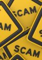 Yellow warning signs displaying "SCAM," highlighting caution against fraud and online schemes. Stay alert with FirmX news.