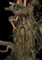 Intricate Treebeard sculpture with detailed textures, lush greenery, and a whimsical fantasy character interaction.