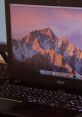 Acer laptop displaying a vibrant mountain landscape backdrop, showcasing its high-resolution screen and illuminated keyboard.