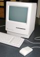 Classic Macintosh computer with keyboard and mouse, showcasing vintage design and early computing technology.