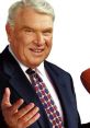 John Madden smiling in a suit, presenting with a football, embodying his legacy in football commentary and coaching.