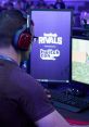 Gamer in headphones focuses on Twitch Rivals tournament gameplay at TwitchCon, showcasing competitive streaming culture.